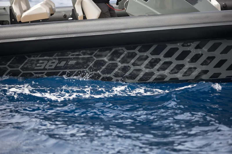 Slide: The Image of 2024 Skipper-BSK 38NC boat on water, close-up of hull design. - 24