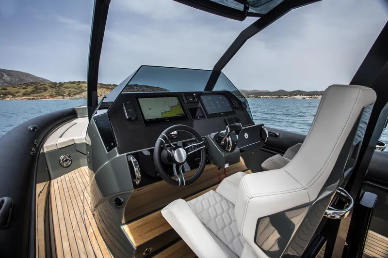 Slide: The Image of Helm of the 2024 Skipper-BSK 38NC boat with dual steering wheels and navigation screens. - 39