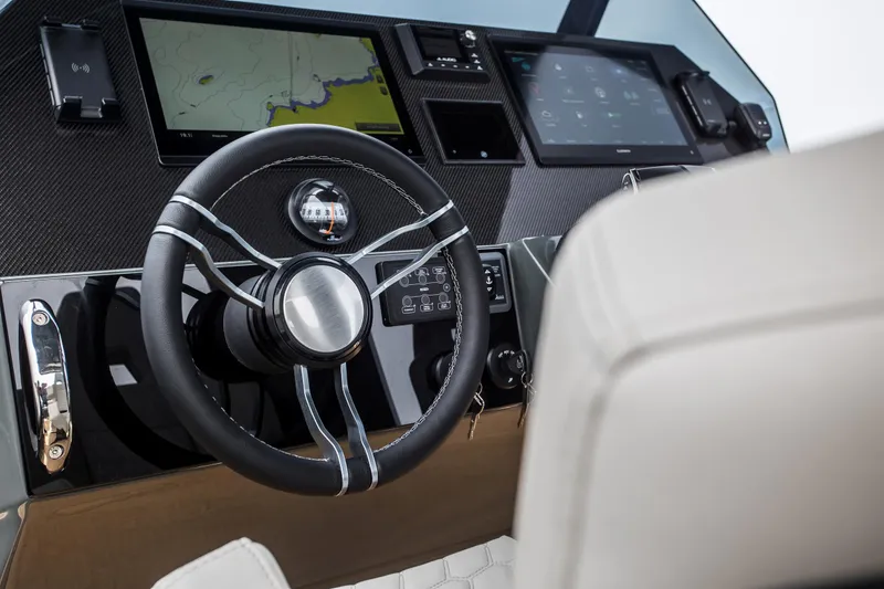 Slide: The Image of Skipper-BSK 38NC 2024 boat dashboard with steering wheel and navigation screens. - 40