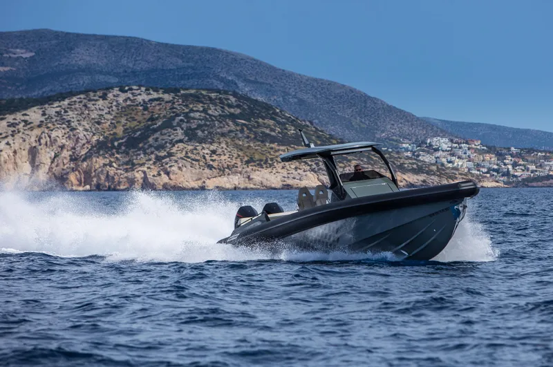 Slide: The Image of 2024 Skipper-BSK 38NC boat cruising on the sea near rocky coastline. - 5