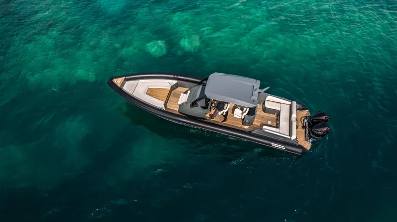 Slide: The Image of 2024 Skipper-BSK 38NC luxury boat cruising on clear turquoise waters. - 3