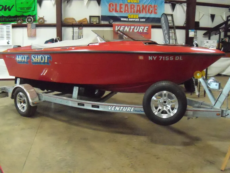 The Image of 1970 Century Mark II red speedboat on Venture trailer in showroom. - 0