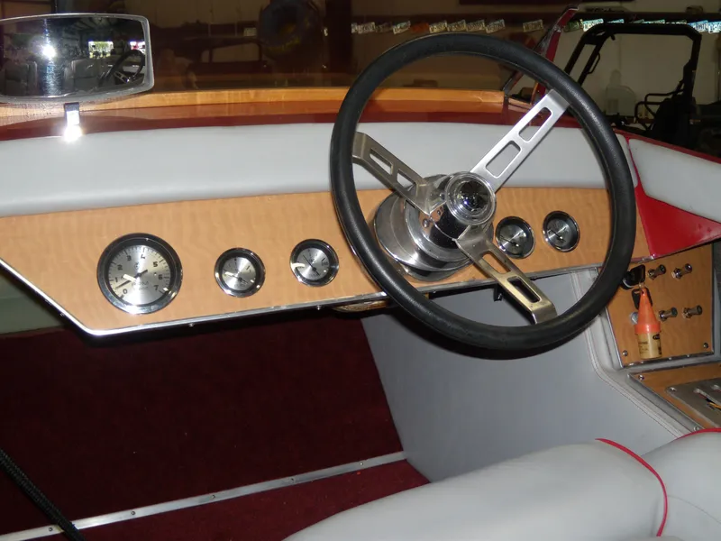 Slide: The Image of 1970 Century Mark II boat dashboard with wooden panel and classic steering wheel. - 15