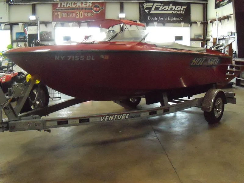 Slide: The Image of 1970 Century Mark II red speedboat on Venture trailer in indoor showroom. - 19
