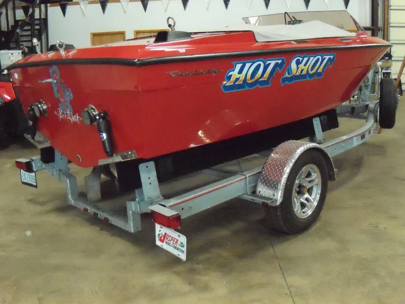 Slide: The Image of 1970 Century Mark II Hot Shot red speedboat on trailer in garage. - 3