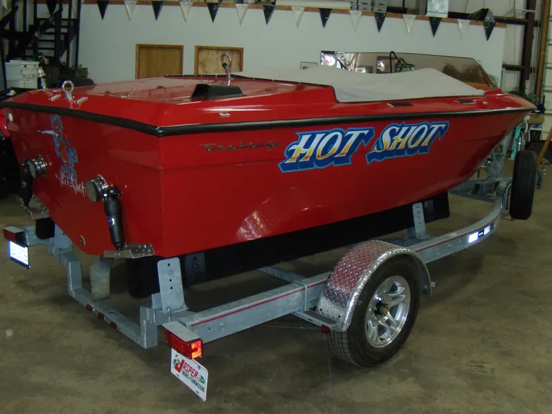 Slide: The Image of 1970 Century Mark II red speedboat Hot Shot on a trailer in a garage. - 6