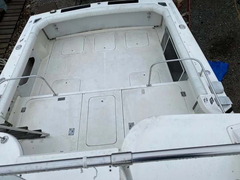 Slide: The Image of 1983 Bertram 28 FB boat deck with storage compartments and railing. - 10