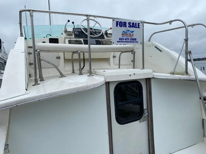 Slide: The Image of 1983 Bertram 28 FB boat for sale, rear view with cockpit and For Sale sign. - 12