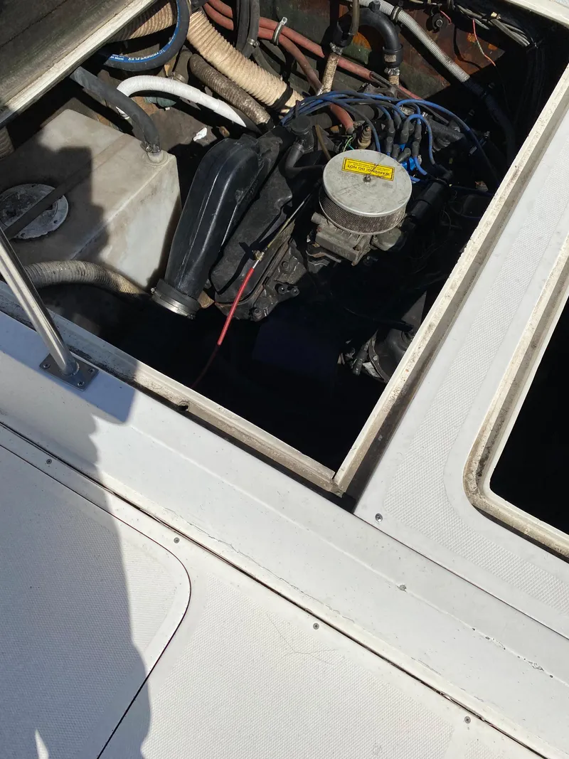 Slide: The Image of Engine compartment of 1983 Bertram 28 FB boat, showing mechanical components. - 17