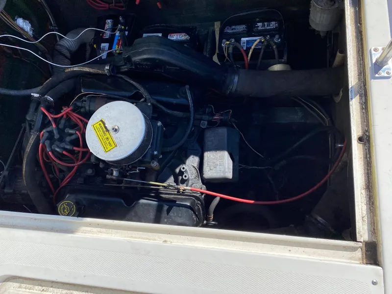 Slide: The Image of 1983 Bertram 28 FB engine compartment with visible wiring and components. - 18