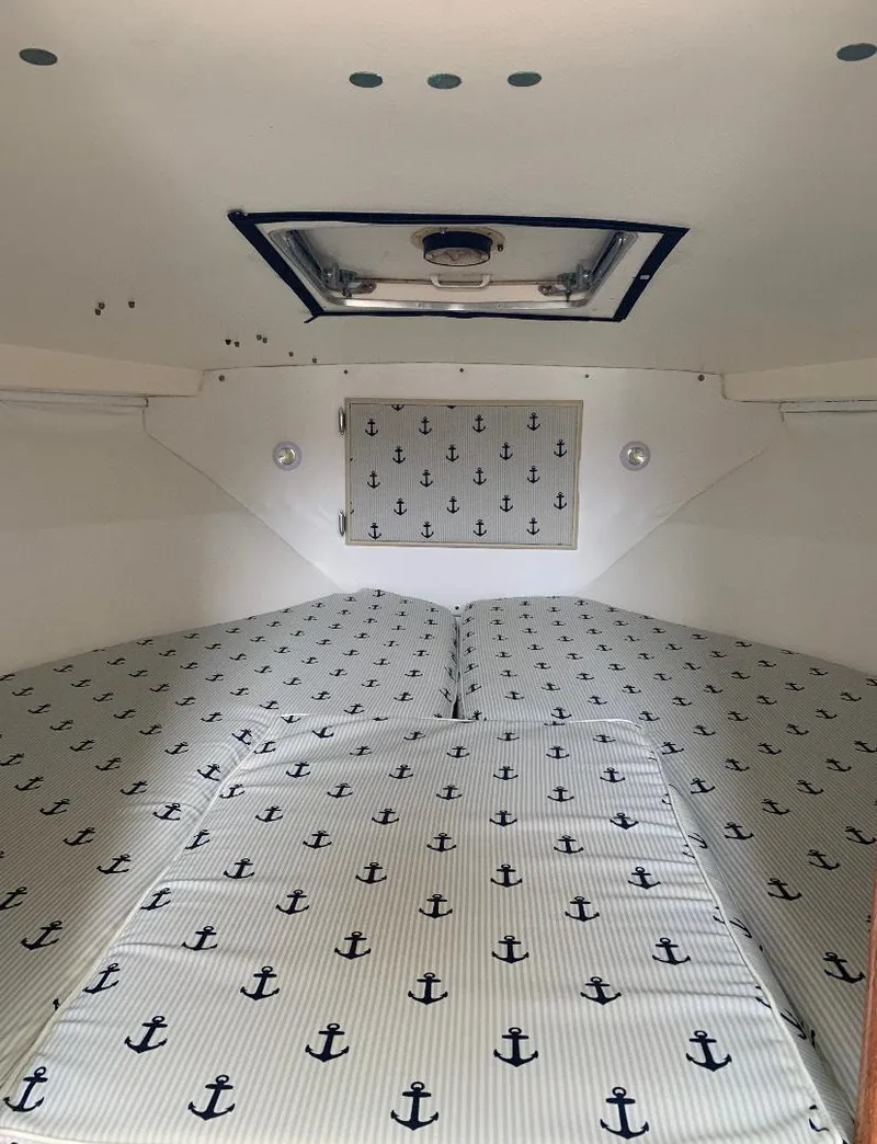 Slide: The Image of 1983 Bertram 28 FB cabin interior with anchor-patterned bedding. - 6