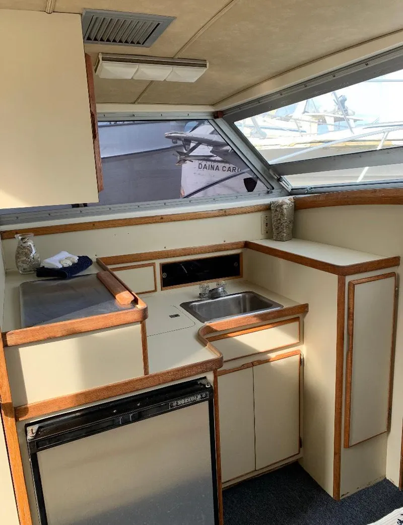 Slide: The Image of 1983 Bertram 28 FB boat interior with kitchenette and sink. - 7