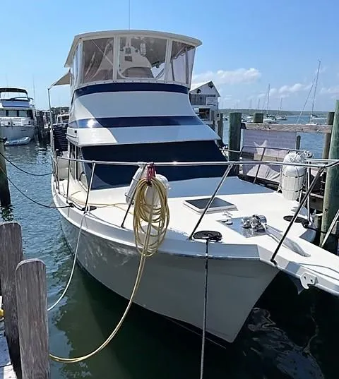 Slide: The Image of 1987 Tollycraft Sundecker Diesel boat docked at marina under clear blue sky. - 2