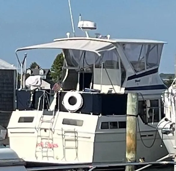 Slide: The Image of 1987 Tollycraft Sundecker Diesel boat docked at a marina. - 28