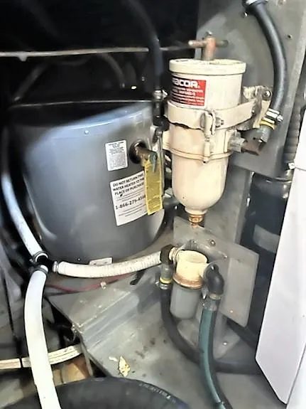 Slide: The Image of Engine compartment of 1987 Tollycraft Sundecker Diesel with fuel filter and hoses. - 29