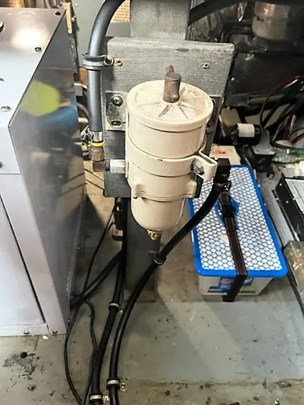 Slide: The Image of 1987 Tollycraft Sundecker Diesel engine component with filter and wiring. - 33