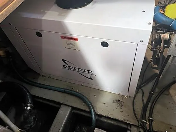 Slide: The Image of 1987 Tollycraft Sundecker Diesel engine room with Norpro generator. - 34