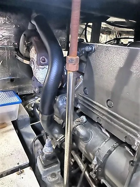 Slide: The Image of 1987 Tollycraft Sundecker Diesel engine close-up, showcasing mechanical components and hoses. - 37