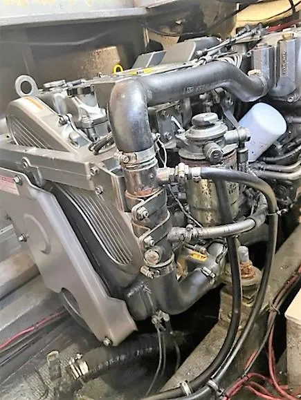 Slide: The Image of 1987 Tollycraft Sundecker Diesel engine with visible pipes and components. - 41