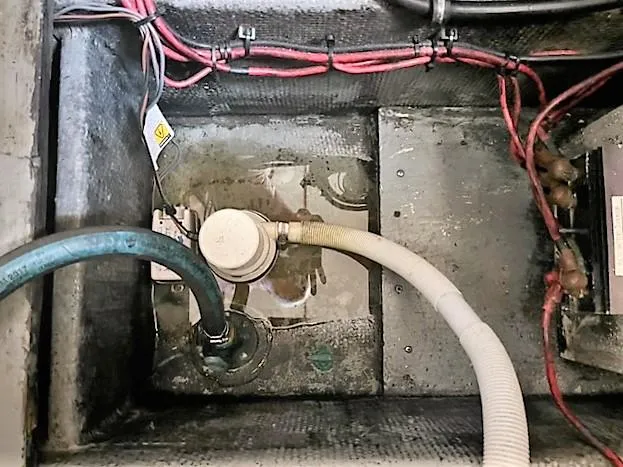 Slide: The Image of 1987 Tollycraft Sundecker Diesel engine compartment with hoses and wiring. - 42