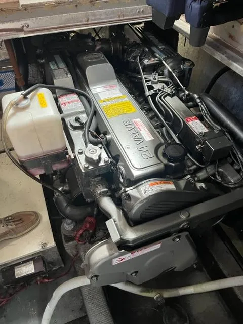 Slide: The Image of Engine compartment of a 1987 Tollycraft Sundecker Diesel boat, showcasing detailed machinery. - 43