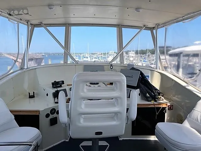 Slide: The Image of 1987 Tollycraft Sundecker Diesel boat helm with marina view. - 7