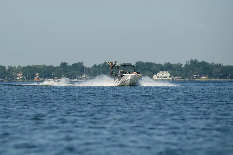 Slide: The Image of 2023 Nautique Super Air GS22E towing a wakeboarder on a lake. - 10