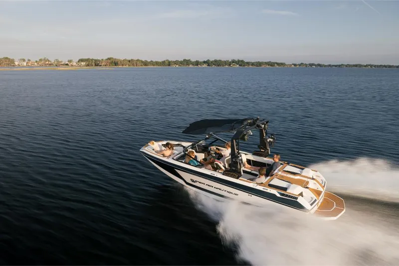 Slide: The Image of 2023 Nautique Super Air GS22E boat cruising on a lake. - 3