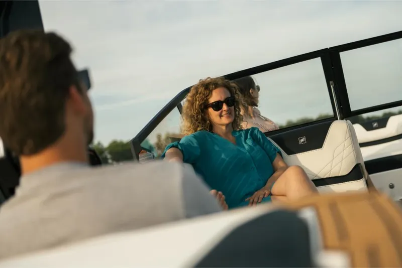 Slide: The Image of 2023 Nautique Super Air GS22E boat with passengers enjoying a sunny day. - 30