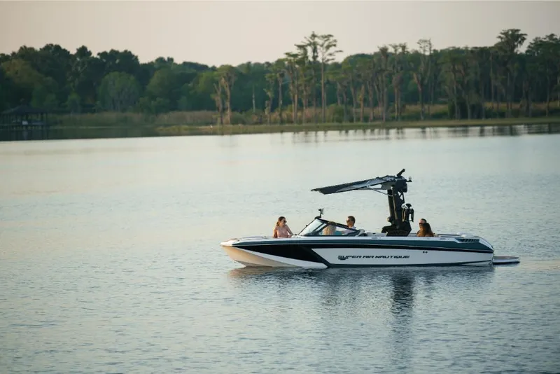 Slide: The Image of 2023 Nautique Super Air GS22E boat on a serene lake. - 4