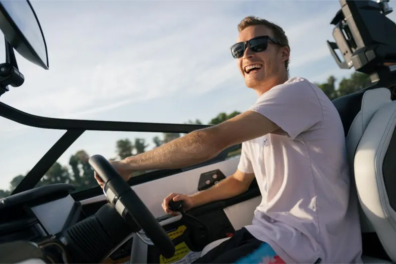 Slide: The Image of Man enjoying a ride on a 2023 Nautique Super Air GS22E boat. - 46