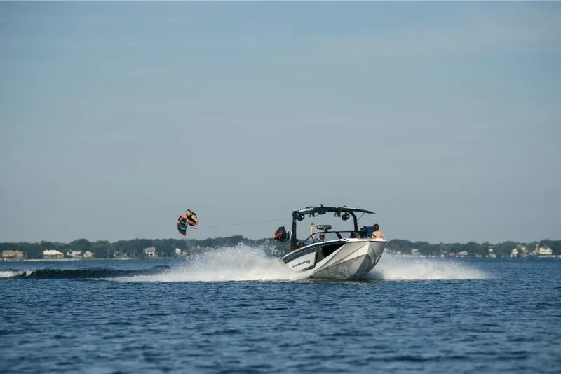 Slide: The Image of 2023 Nautique Super Air GS22E towing a wakeboarder on a lake. - 5