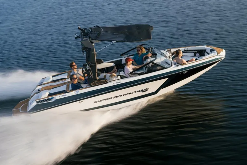Slide: The Image of 2023 Nautique Super Air GS22E boat speeding on water with passengers. - 9