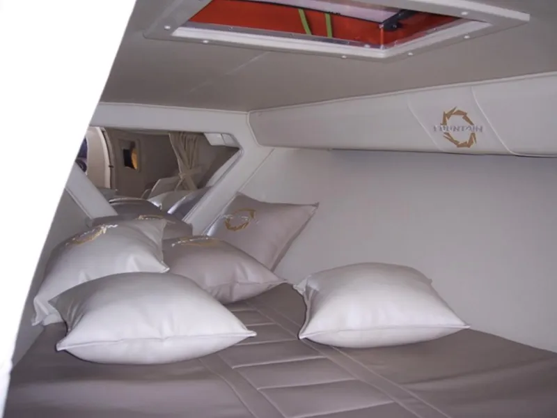 Slide: The Image of Interior cabin of a 2007 Fountain 38 Lightning boat with pillows and bedding. - 10