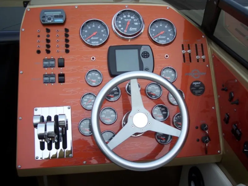 Slide: The Image of 2007 Fountain 38 Lightning boat dashboard with gauges, controls, and steering wheel. - 15