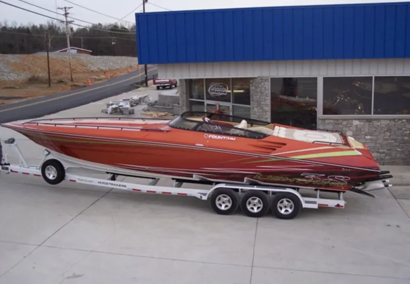 Slide: The Image of 2007 Fountain 38 Lightning speedboat on a trailer outside a dealership. - 3