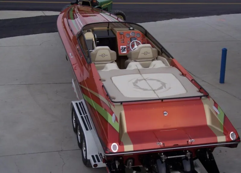 Slide: The Image of 2007 Fountain 38 Lightning speedboat on trailer, red and beige color scheme. - 5