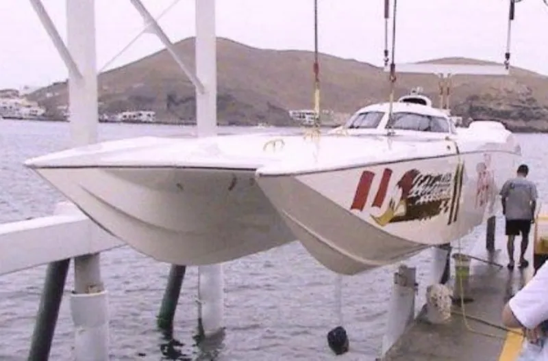 Slide: The Image of 2006 MTI 44 powerboat being lifted out of the water. - 2