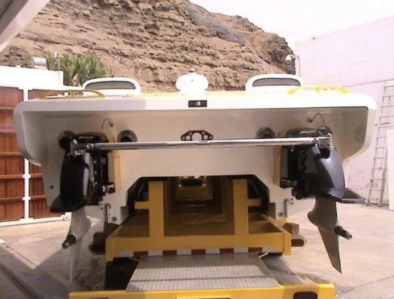 Slide: The Image of Rear view of a 2006 MTI 44 boat on a yellow trailer. - 3