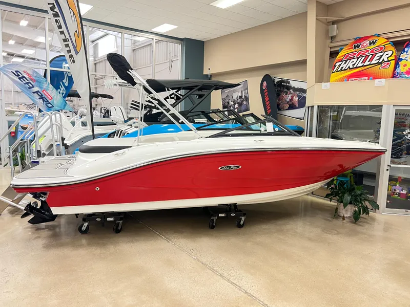 Slide: The Image of 2023 Sea Ray SPX 190 boat in showroom, red and white exterior. - 0