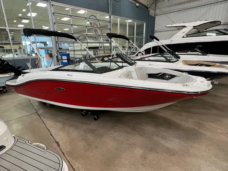 Slide: The Image of 2023 Sea Ray SPX 190 boat with red hull in showroom. - 11