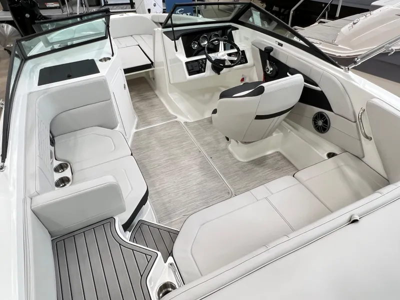Slide: The Image of 2023 Sea Ray SPX 190 boat interior with white seating and modern dashboard. - 4