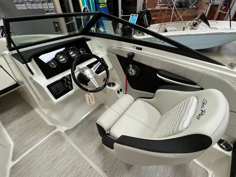 Slide: The Image of 2023 Sea Ray SPX 190 boat interior, featuring steering wheel and captain's seat. - 7