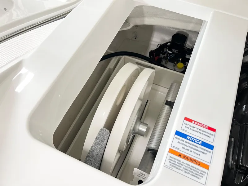 Slide: The Image of 2023 Sea Ray SPX 230 boat engine compartment with safety labels. - 11
