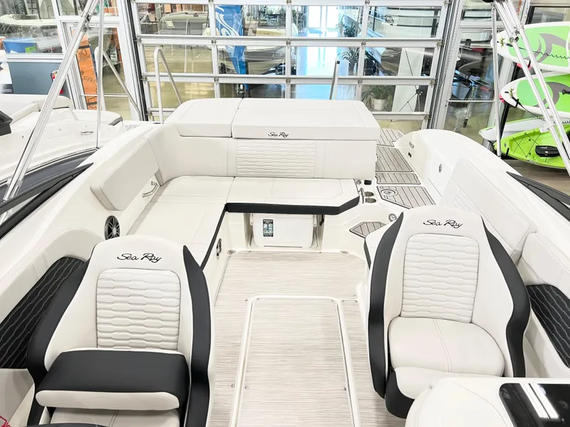 Slide: The Image of 2023 Sea Ray SPX 230 boat interior with white seating and modern design. - 2