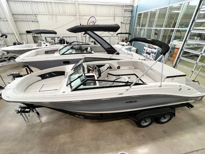 Slide: The Image of 2023 Sea Ray SPX 230 boat in showroom, featuring sleek design and modern amenities. - 3