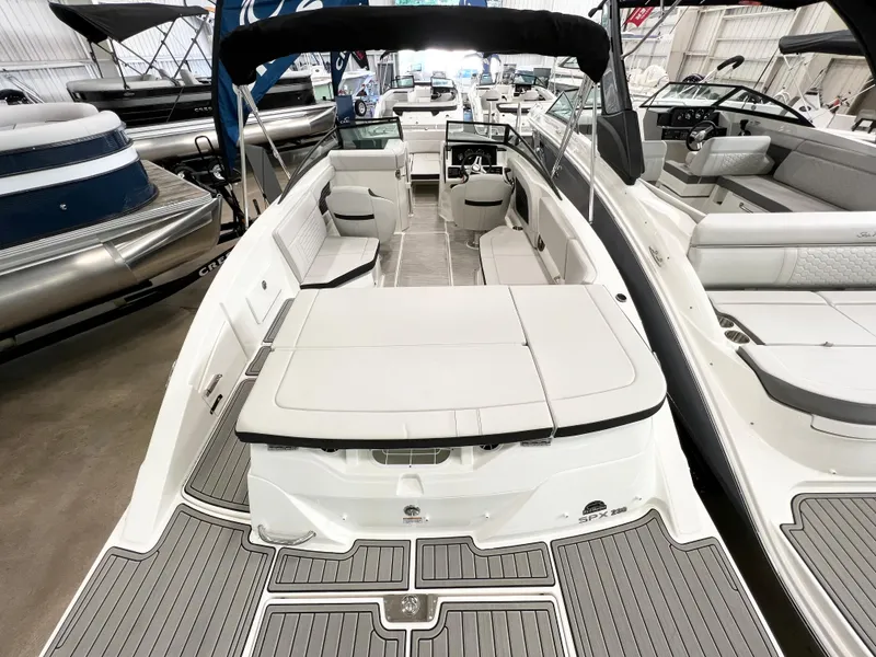 Slide: The Image of 2023 Sea Ray SPX 230 boat interior with spacious seating and modern design. - 4