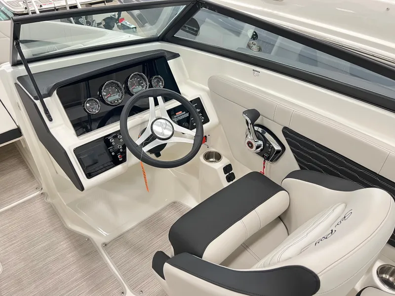 Slide: The Image of 2023 Sea Ray SPX 230 boat interior with steering wheel and dashboard controls. - 6