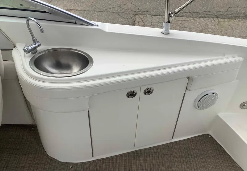 Slide: The Image of Sea Ray 26 Bow Rider 2012 boat sink and storage area. - 4