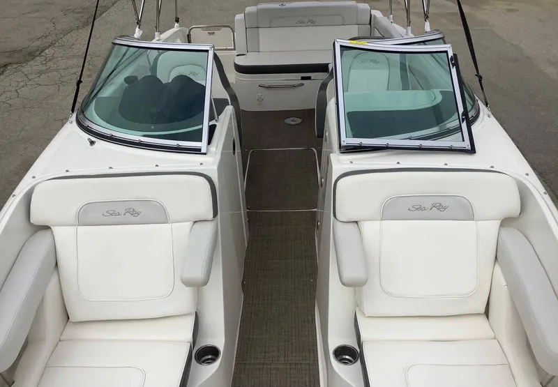 Slide: The Image of 2012 Sea Ray 26 Bow Rider boat interior with white seating and open windshield. - 6